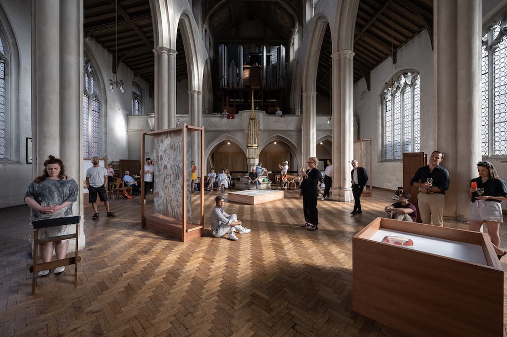 Installtion shot of performers and artworks in St. Cyprians Church, with audience in the background